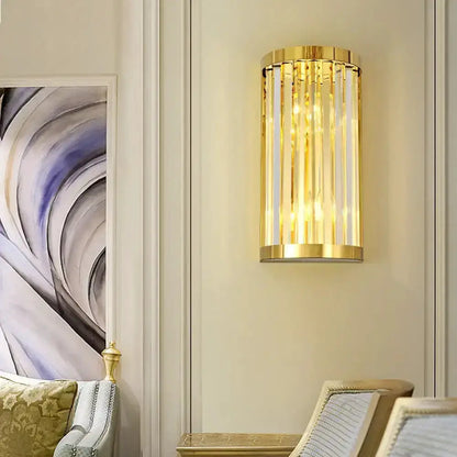 Modern gold crystal wall sconce by Decorbites, gold cylindrical frame with hanging prisms on Tampa Home & Garden Store