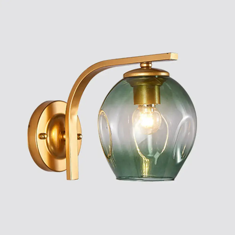 Modern gold curved arm glass wall sconce with green-tinted shade by Decorbites for bedroom on Tampa Home & Garden Store