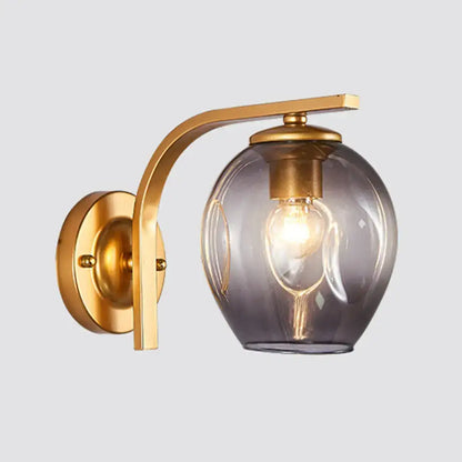 Modern gold curved arm glass wall sconce with smoky gray glass shade by Decorbites on Tampa Home & Garden Store