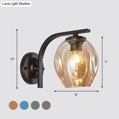 Modern gold curved arm glass wall sconce with amber glass shade for bedroom on Tampa Home & Garden Store