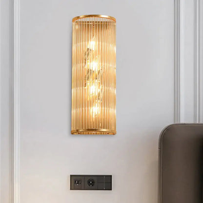 Gold crystal cylinder wall lamp by Decorbites, gold metal frame with vertical glass rods on Tampa Home & Garden Store