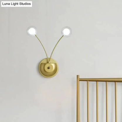 Modern gold double-arm wall lamp globe glass fixture with two globes and round backplate on Tampa Home & Garden Store