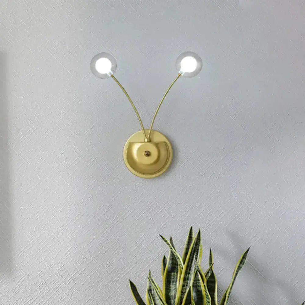 Modern gold double-arm wall lamp with glass globe bulbs on Tampa Home & Garden Store
