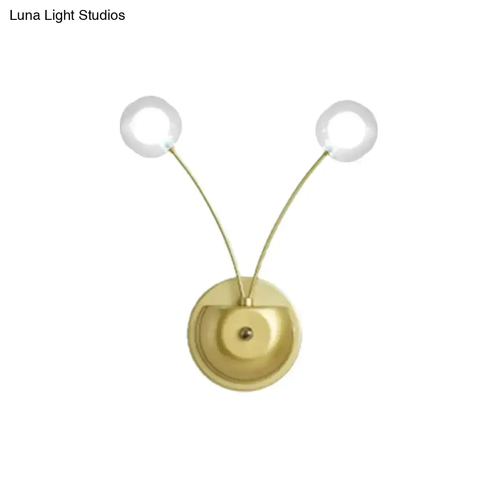 Gold modern dual-arm wall lamp with two round glass globes and brass backplate Decorbites on Tampa Home & Garden Store