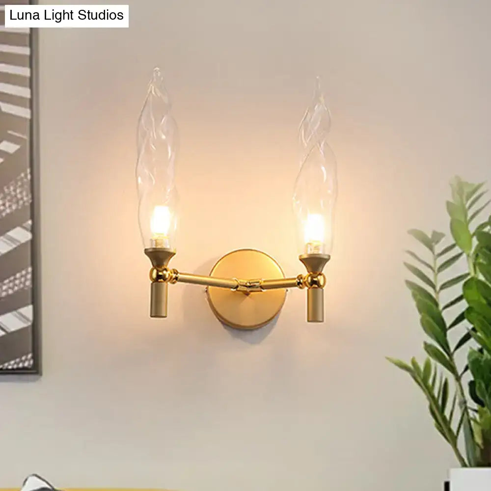 Decorbites gold double-arm wall sconce with round brass backplate and two candle bulbs on Tampa Home & Garden Store