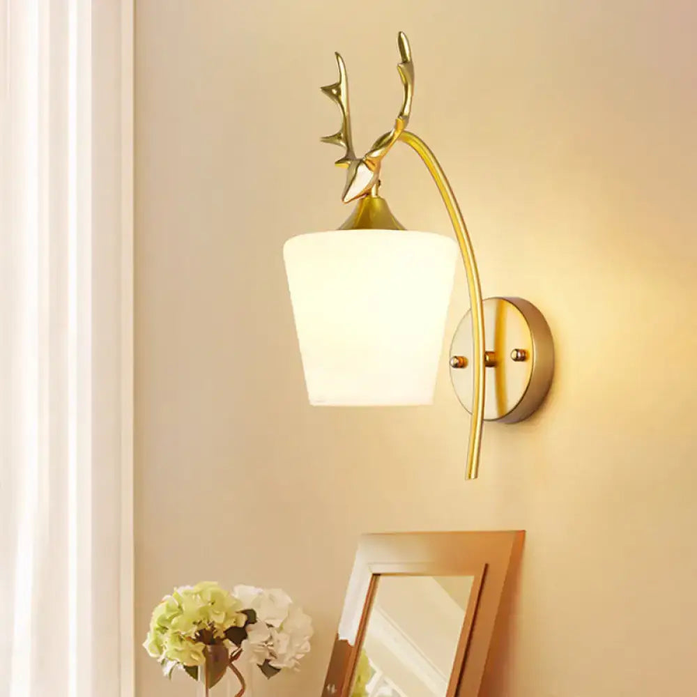 Decorbites gold elk wall sconce with curved brass arm and frosted glass shade on Tampa Home & Garden Store
