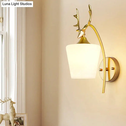 Gold Elk Wall Sconce by Decorbites with antler motif, brass finish, and white glass shade on Tampa Home & Garden Store