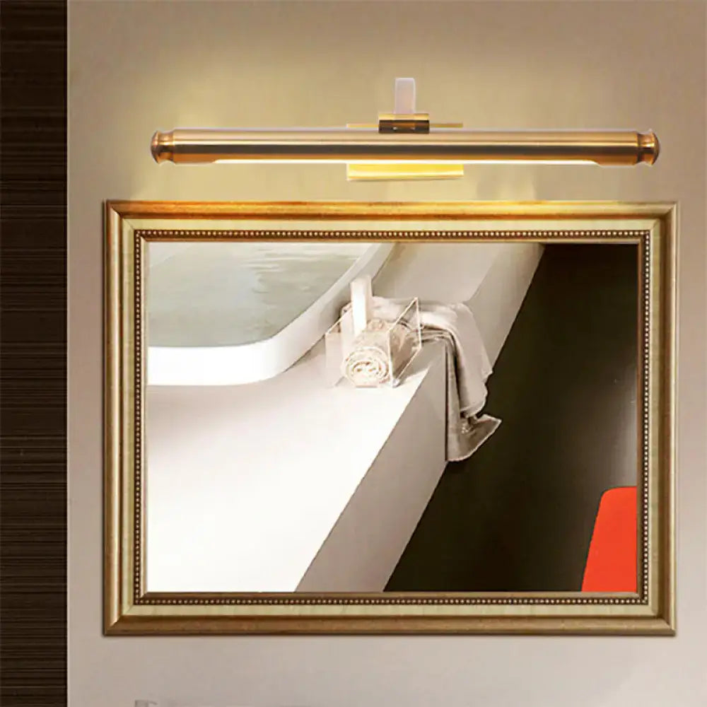 Gold-tube vanity light with brass finish mounted above a framed bathroom mirror on Tampa Home & Garden Store