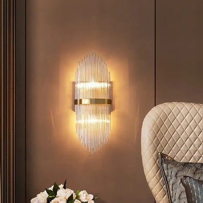 Gold Flute Crystal Sconce with vertical glass prisms and a gold band, warm ambient lighting on Tampa Home & Garden Store