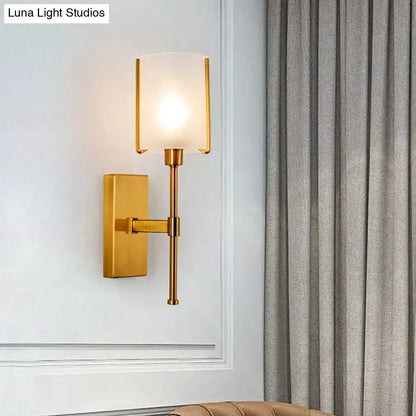 Wall sconce with modern gold frosted glass and pencil arm by Decorbites Luna Light Studios watermark on Tampa Home & Garden Store