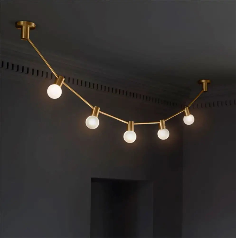 Gold Bubble Wall Light by Decorbites: six globe bulbs on a gold cord on Tampa Home & Garden Store