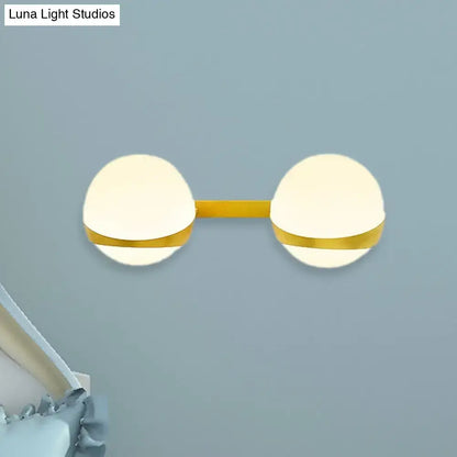 Gold Frosted Glass Two-Bulb Sconce by Decorbites, gold bar spans frosted glass globes on Tampa Home & Garden Store