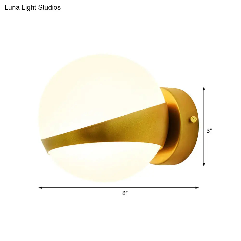 Gold frosted glass two-bulb sconce by Decorbites with curved brass arm and round backplate on Tampa Home & Garden Store