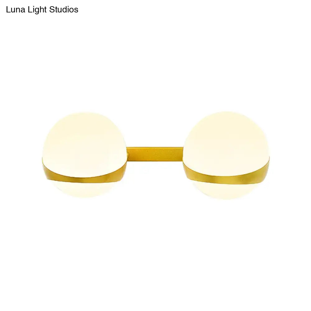 Gold frosted glass two-bulb sconce with gold bar on Tampa Home & Garden Store