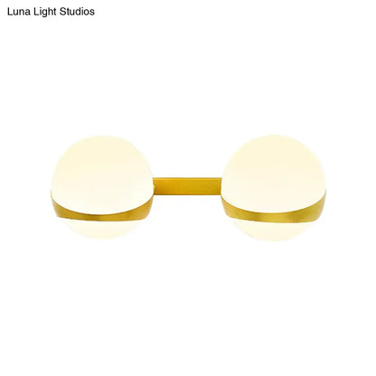Gold frosted glass two-bulb sconce with gold bar on Tampa Home & Garden Store