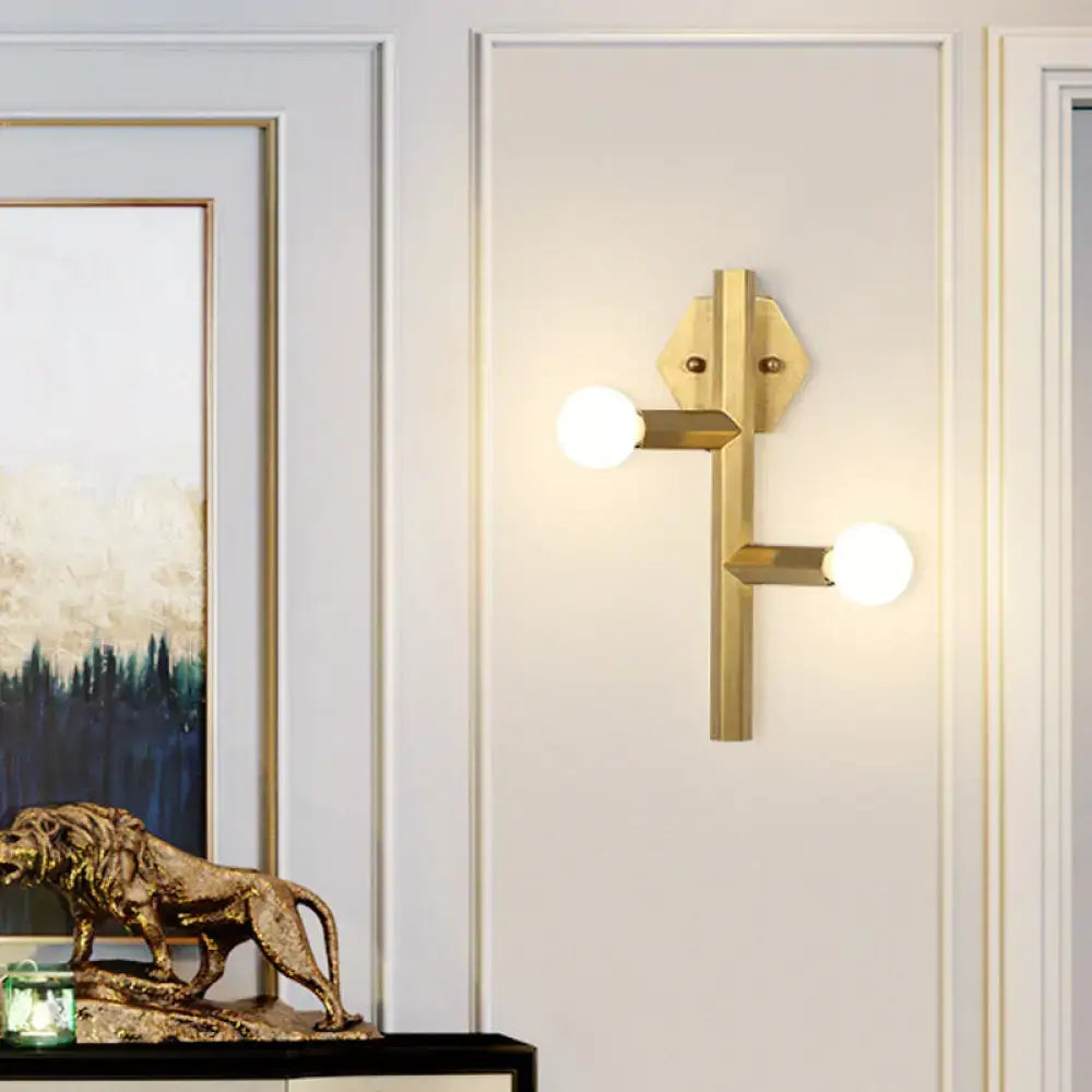 Gold vertical tube bedroom wall light with dual arms and white globe bulbs in brass finish on Tampa Home & Garden Store