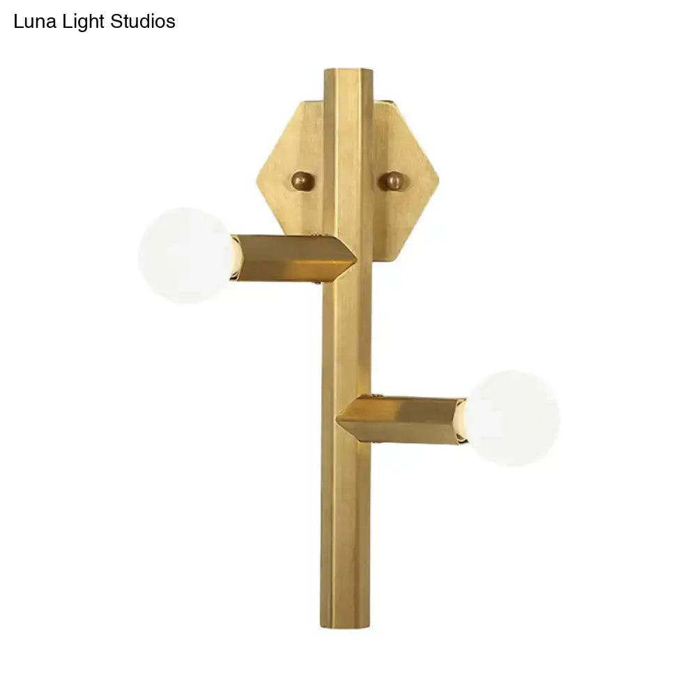 Gold vertical tube bedroom wall light with two horizontal arms and white globe bulbs on Tampa Home & Garden Store