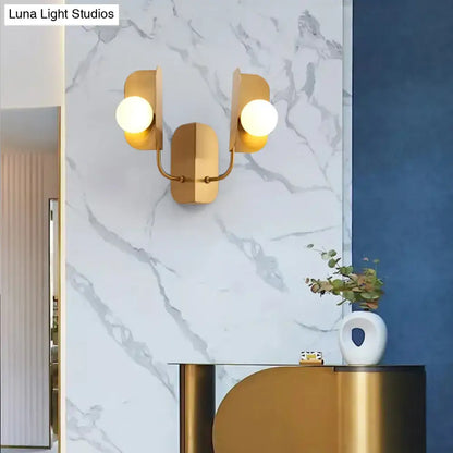 Gold Globe Wall Sconce with dual globe bulbs in gold finish mounted on marble wall on Tampa Home & Garden Store