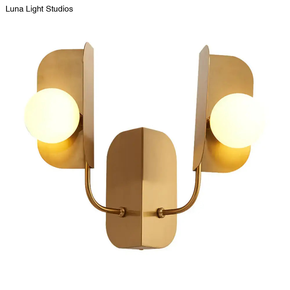 Gold Globe Wall Sconce with two frosted glass globes on curved gold arms and a backplate on Tampa Home & Garden Store