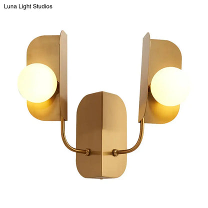 Gold Globe Wall Sconce with two frosted glass globes on curved gold arms and a backplate on Tampa Home & Garden Store