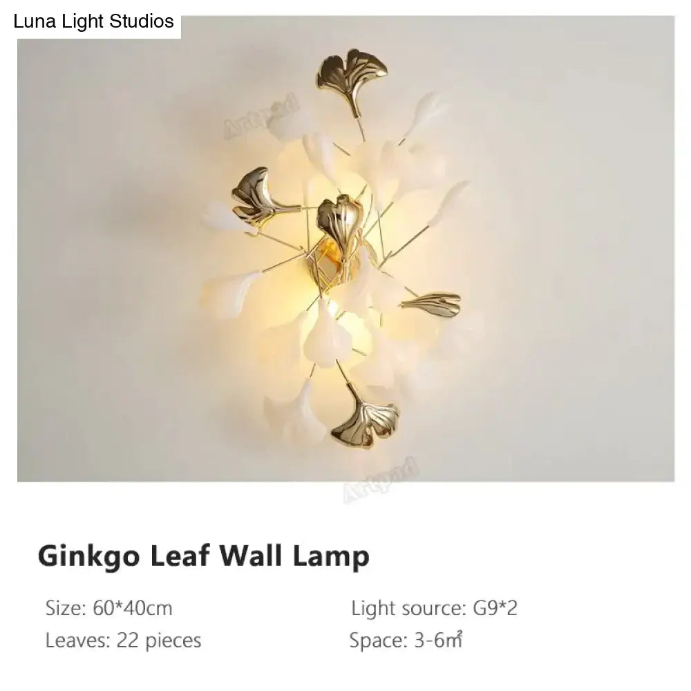 Gold Ginkgo Porcelain Wall Sconce with 22 leaf accents and warm backlit glow on Tampa Home & Garden Store