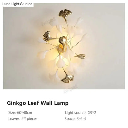 Gold Ginkgo Porcelain Wall Sconce with 22 leaf accents and warm backlit glow on Tampa Home & Garden Store