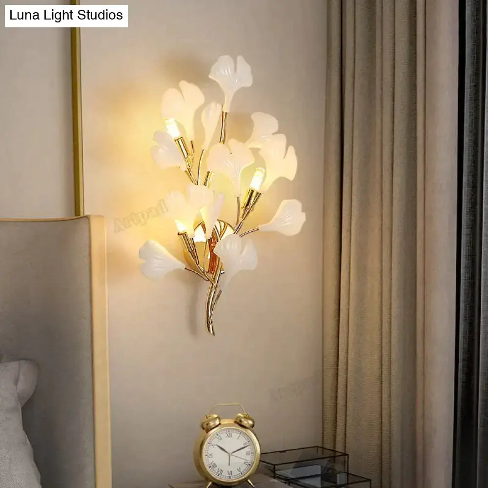 Decorbites Gold Ginkgo porcelain wall sconce with white leaves on gold branches, warm glow on Tampa Home & Garden Store
