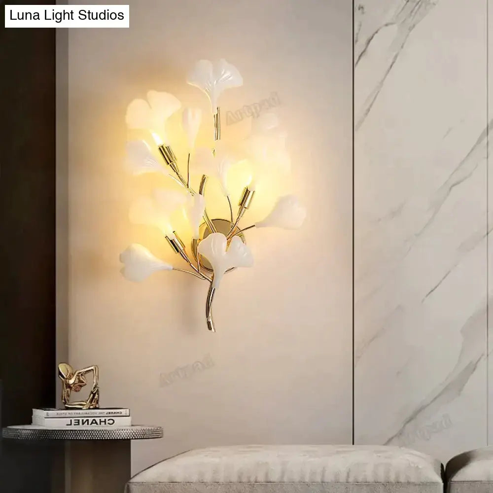 Gold Ginkgo Porcelain Wall Sconce by Decorbites with white leaf petals and warm glow on Tampa Home & Garden Store