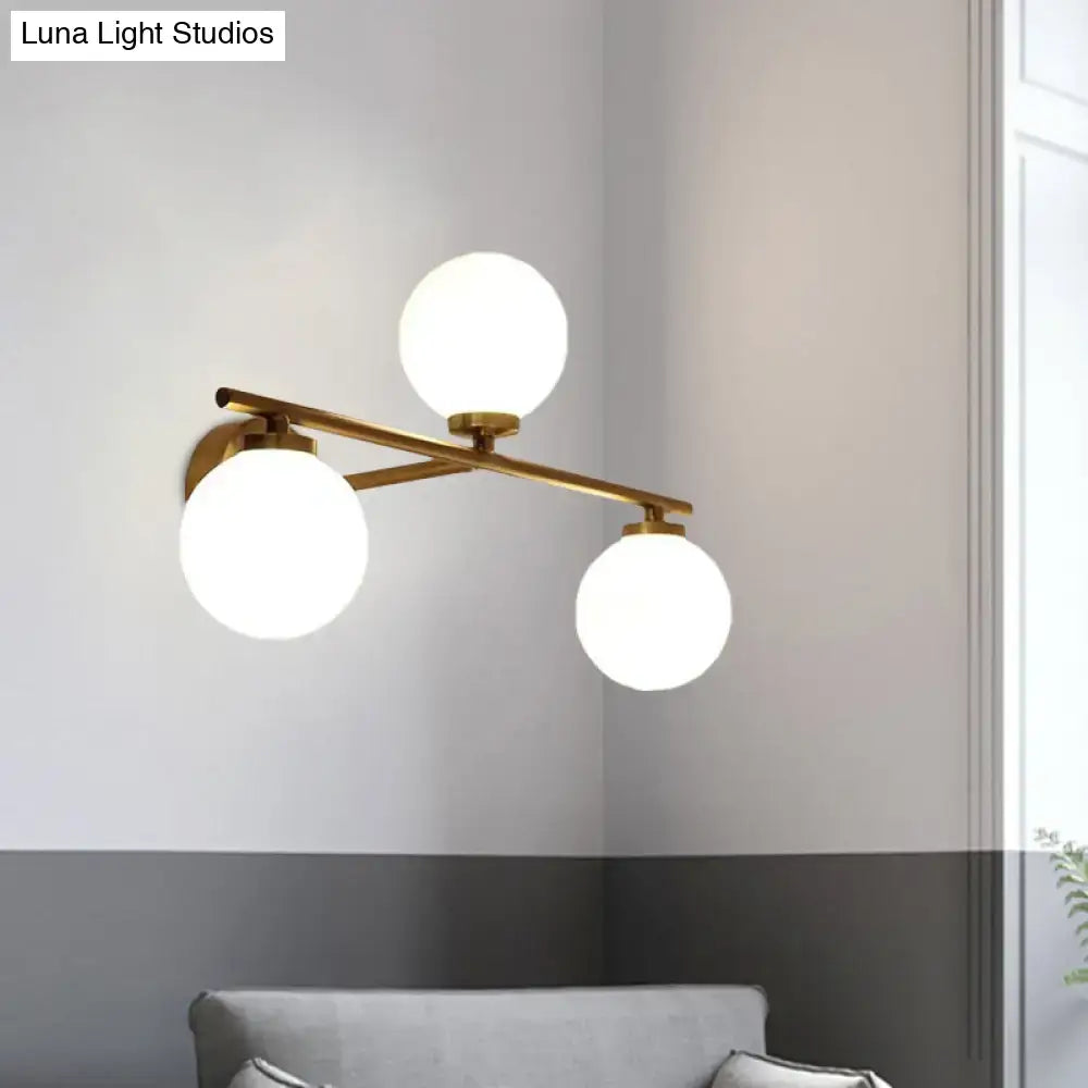 Gold opal glass hallway sconce with three spherical diffusers on brass bar by Decorbites on Tampa Home & Garden Store