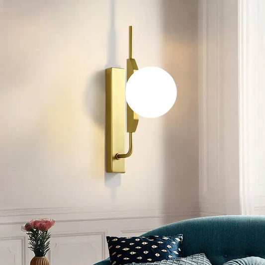 Gold milky glass wall sconce by Decorbites; round white globe on brass mount on Tampa Home & Garden Store
