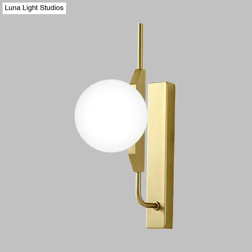 Gold Milky Glass Wall Sconce with white globe shade and brass backplate on Tampa Home & Garden Store