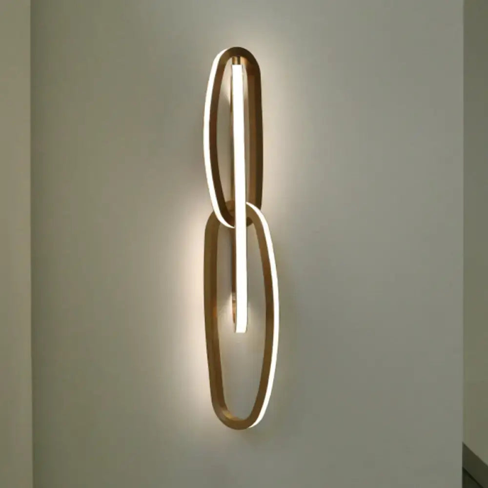 Gold oval wall lamp by Decorbites with two linked oval rings and vertical LED light on Tampa Home & Garden Store