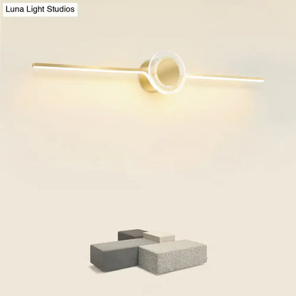 Modern gold linear LED wall sconce with circular ring detail for bathroom and concrete blocks on Tampa Home & Garden Store