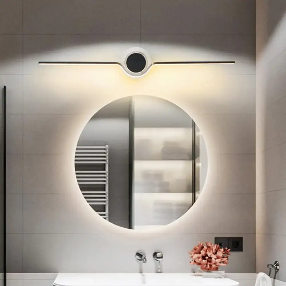 Modern gold linear LED bathroom wall sconce above round backlit mirror on Tampa Home & Garden Store