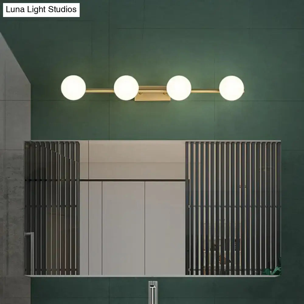 Decorbites gold milky-glass bathroom five-light sconce with frosted globe shades on green wall on Tampa Home & Garden Store