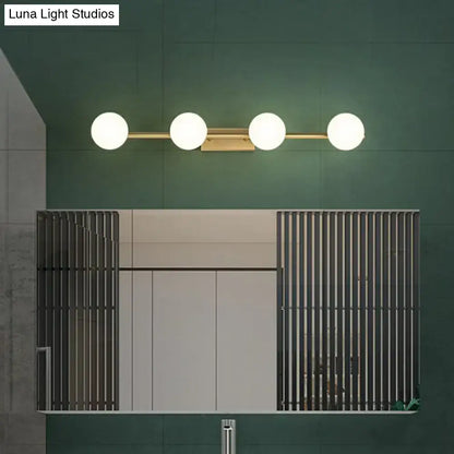 Decorbites gold milky-glass bathroom five-light sconce with frosted globe shades on green wall on Tampa Home & Garden Store