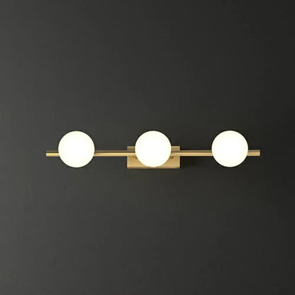 Gold milky glass bathroom sconce with three spherical globes on brass bar on Tampa Home & Garden Store