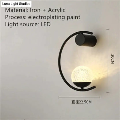 Black iron crescent wall light with frosted glass globe, LED bedroom sconce on Tampa Home & Garden Store