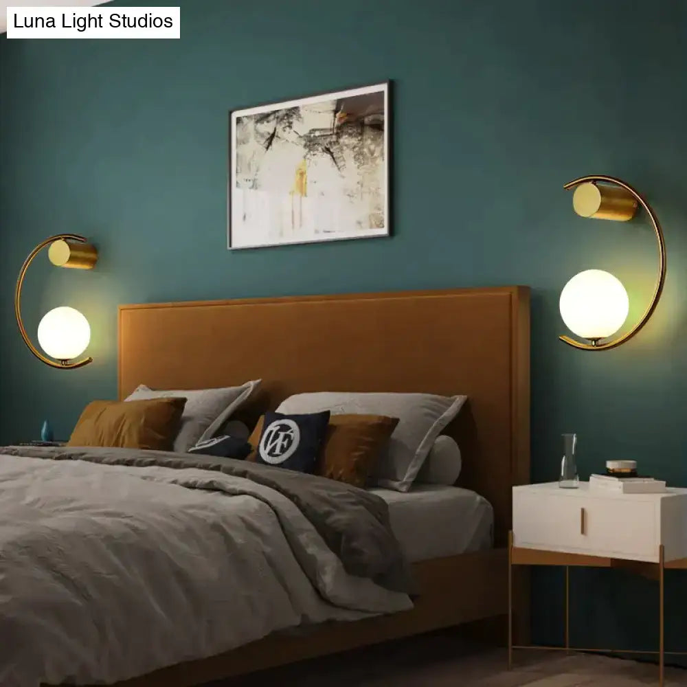 Decorbites gold LED bedside wall lamp sconce with curved arc, two lamps on teal wall on Tampa Home & Garden Store