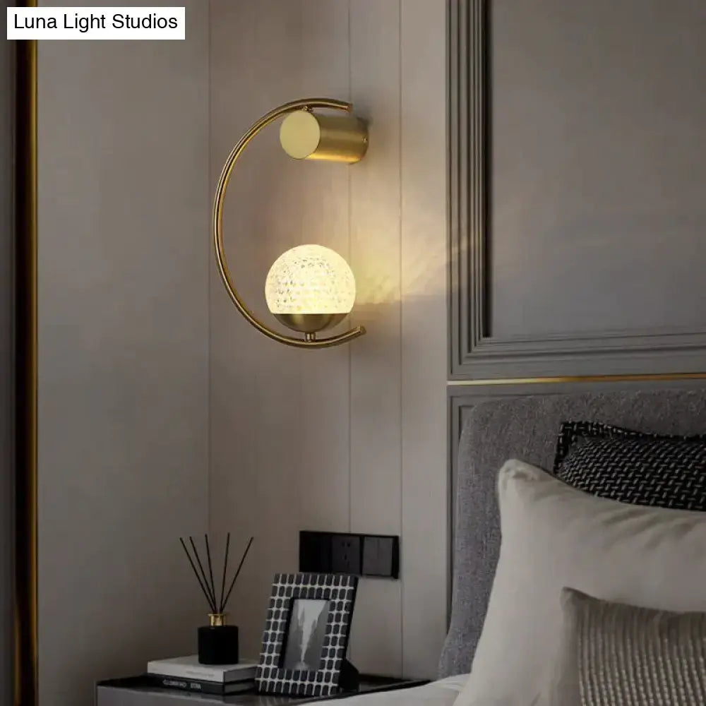Bedside wall lamp Decorbites: modern gold metal sconce with arc frame and textured globe on Tampa Home & Garden Store