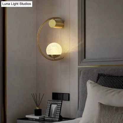 Bedside wall lamp Decorbites: modern gold metal sconce with arc frame and textured globe on Tampa Home & Garden Store