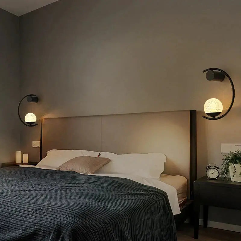 Bedside wall light by Decorbites, modern gold LED with curved arc and frosted globe, two sconces on Tampa Home & Garden Store