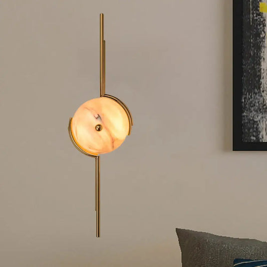 Gold marble LED wall light with round marble disc on a vertical gold metal mount on Tampa Home & Garden Store