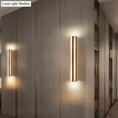 Modern gold metal wall lamp pair for corridor; cylindrical backlit sconces with warm glow on Tampa Home & Garden Store