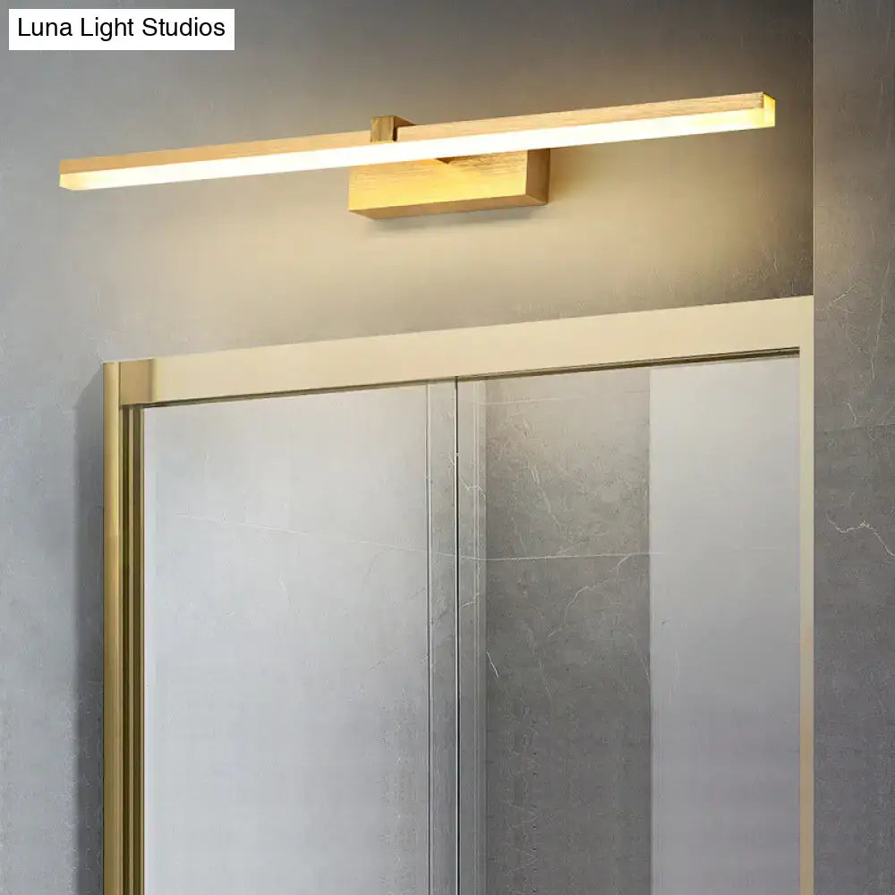 Gold LED vanity light bar by Decorbites, wall-mounted with wooden block above mirror on Tampa Home & Garden Store
