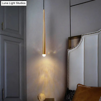 Gold tapered shade sconce by Decorbites, slim brass cylinder emits warm bedside glow on Tampa Home & Garden Store