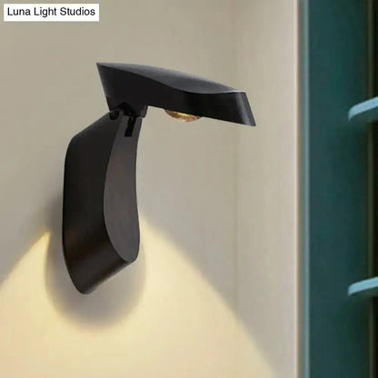 Black metal wall light bedside fixture with curved arm and slim downward shade on Tampa Home & Garden Store
