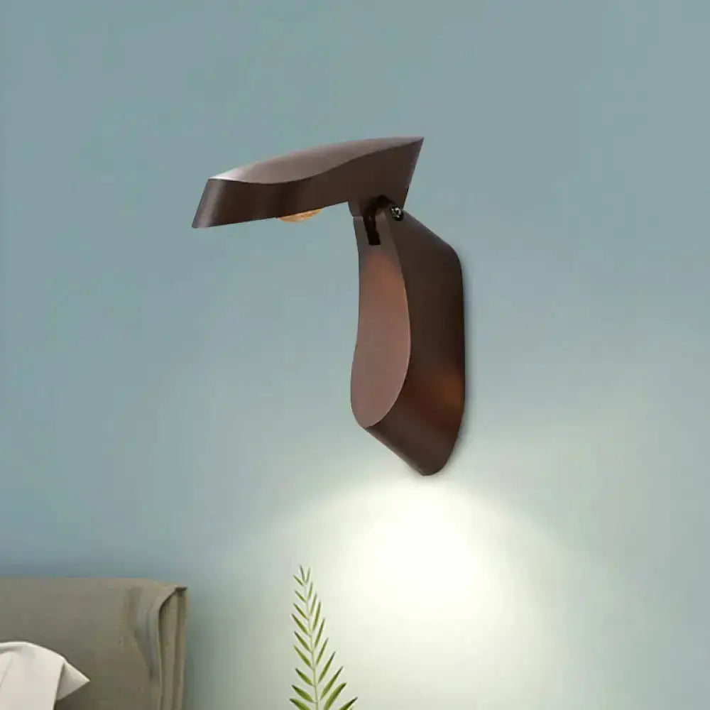 Modern gold metal wall light bedside fixture with curved arm, casts downward glow on wall on Tampa Home & Garden Store