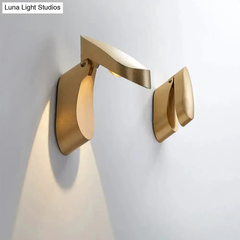 Pair of modern gold metal wall sconces with curved arm and geometric backplates by Decorbites on Tampa Home & Garden Store
