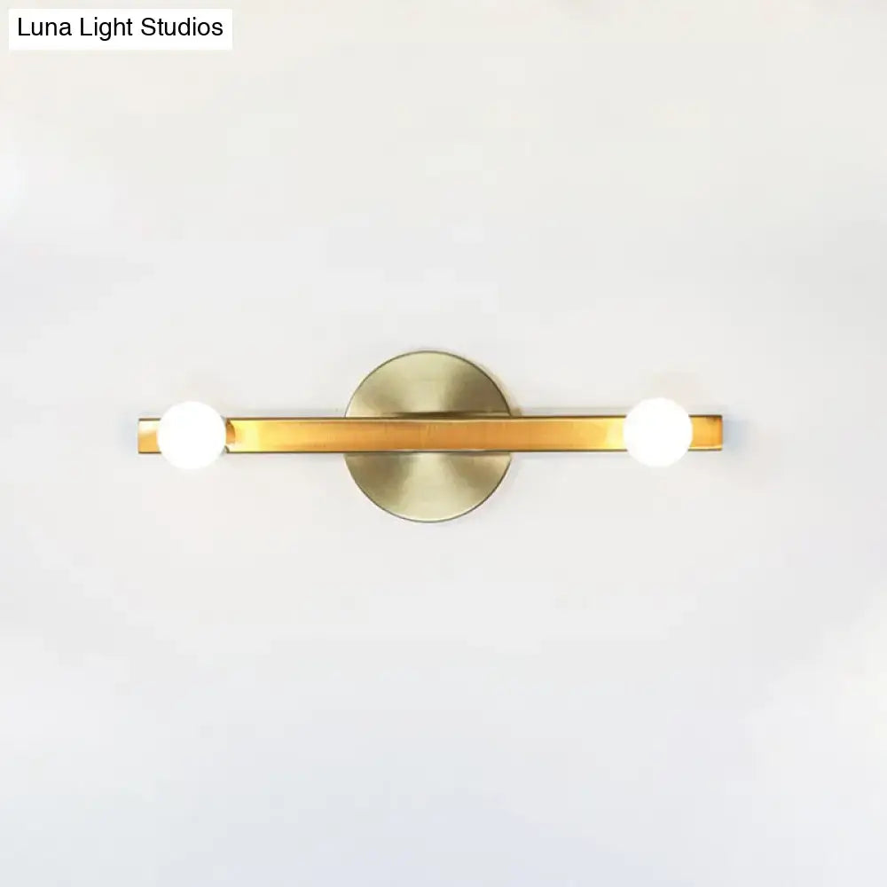 Gold Linear Warm Glow Vanity Light with brass bar and two white globe bulbs on a backplate on Tampa Home & Garden Store